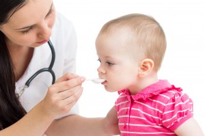 doctor giving remedy to baby girl
