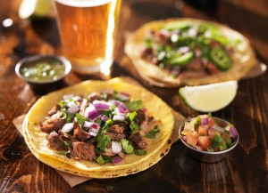 authentic mexican tacos with beer on wooden table shot with sele