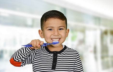 Young child who is brushing their teeth