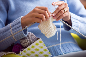 Female hands with knitting needles while knitting. Knitting therapy