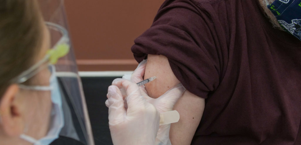 enfermera vacunando a una persona contra el covid