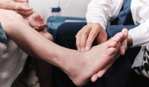 Doctor revisando los pies a un paciente
